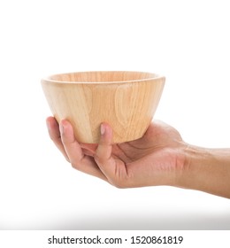 The human's hand is holding an empty Wooden bowl, that made from rubberwood for being a food container, isolated on white background with a clipping path.