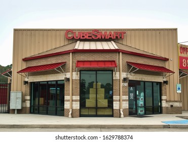 Humble, Texas USA 01-01-2020: Cube Smart Business Exterior In Humble, TX. Self-storage Facility Chain Founded In 2004. Metal Storefront With Red Awnings And Cardboard Boxes Visible Inside Facility.