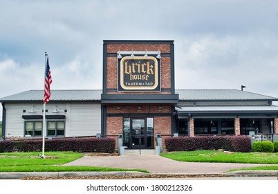 Humble, Texas USA 03-25-2020: Brick House Tavern And Tap Sports Bar Exterior In Humble TX. USA Flag Out Front Overlooking The Empty Parking Lot.