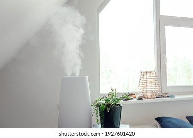 Humidifier Adds Water To The Air By Boiling Water Into Steam. Reduces Dry Air, Healthy Home Environment Which Can Help Relieve A Stuffy Nose. Health Benefits. White Bright Home Decor.