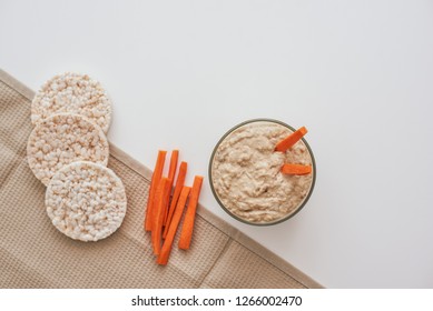 Hummus With Carrot Sticks. Top View Oh Humus With Carrot Isolated On White Background.