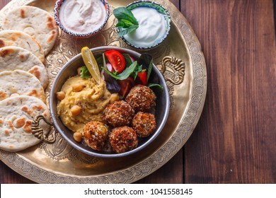 Hummus, Falafel, Salad In A Pan With Yoghurt And Tahini