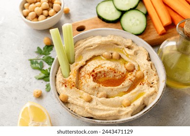 Hummus with fresh vegetables celery, carrots, cucumber, with chickpeas paprika  and olive oil, healthy lunch food - Powered by Shutterstock