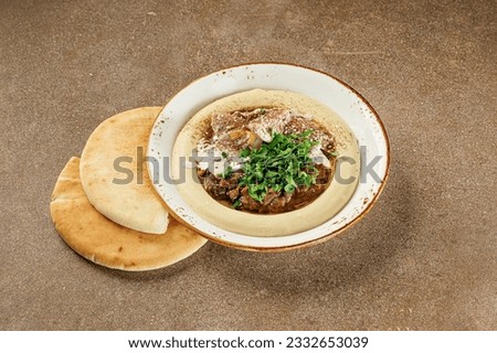 Hummus. Large bowl of homemade hummus garnished, middle east food