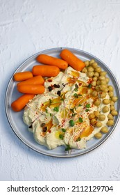 Hummus With Olive Oil And Baby Carrots On A Plate.