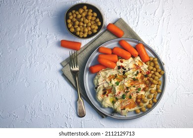 Hummus With Olive Oil And Baby Carrots On A Plate.