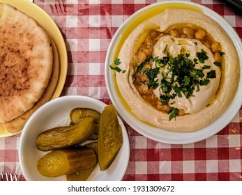 Hummus with Olive Oil, Herbs, Chickpeas, Pickles and Pita on the Mediterranen in Jaffa, Tel Aviv, Israel