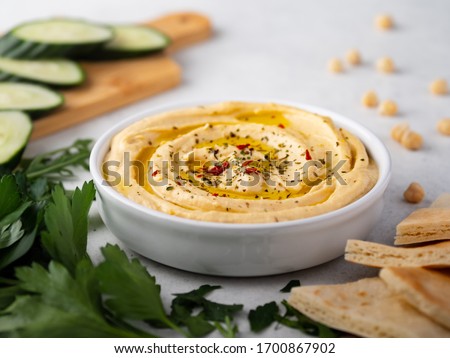 Hummus plate with cucumber slices and parsley Stok fotoğraf © 