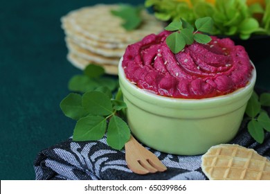 Hummus with roasted beetroot, olive oil, tortilla chips and vegetables. Copy space