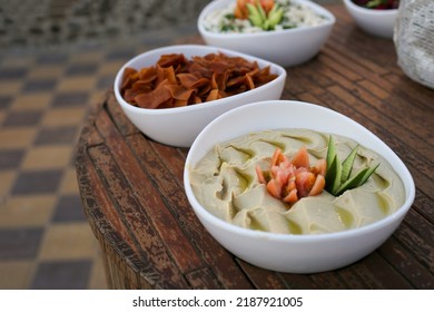 Hummus In White Plate On Wooden Table. Arabic Dish