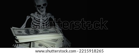 Humorous conceptual image of skeleton skull with US Dollar money as symbol of wealth and greed. Copy space. Foto stock © 
