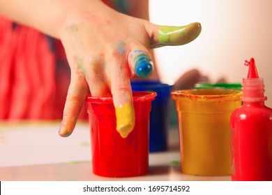 Humorous Image Of Child Girl Great Artist Painting A Picture With Finger. Painting Process And Education Concept.