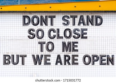 Humorous Social Distancing Sign Outside Open Business During Coronavirus Pandemic