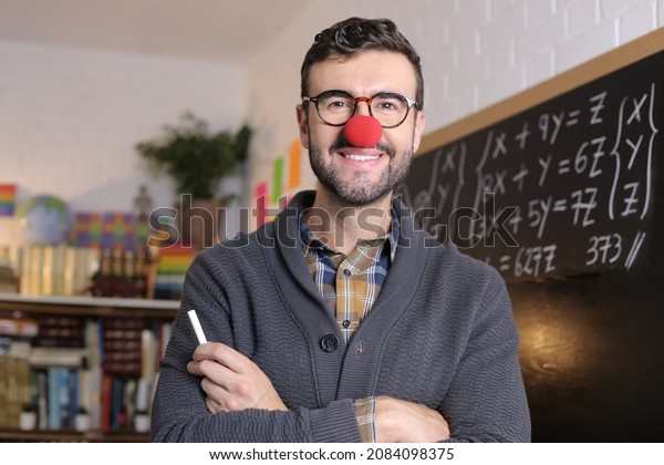 Humorous teacher wearing\
red clown nose
