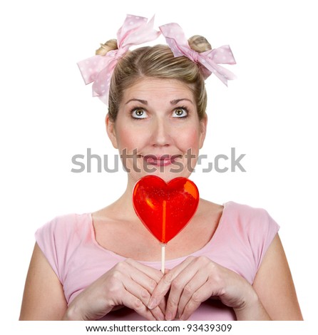 Humorous woman holding a red valentines heart, isolated on a white background