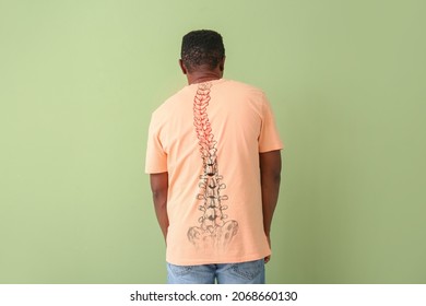 Hunchbacked African-American man on color background