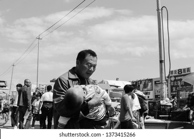 Hunchun, China - 09.01.13: The Father Holds The Child