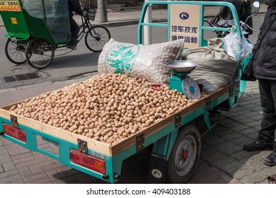 HUNCHUN, CHINA - MARCH 31, 2012: Pile Of Walnuts In A Street Market In Hunchun City. Hunchun Is A County-level City In The Yanbian Korean Autonomous Prefecture.