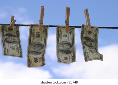 Hundred dollar bills hanging on a rope.
 Money laundering concept 
