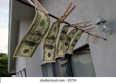 Hundred dollar bills hanging on a rope.
 Money laundering concept 
