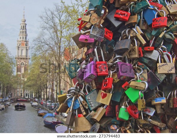 Hundreds of padlocks (called love locks) in
Amsterdam, Netherlands. People close these locks on the cables /
suspension ropes of a bridge crossing a canal (so called gracht) as
a sign of eternal
love.