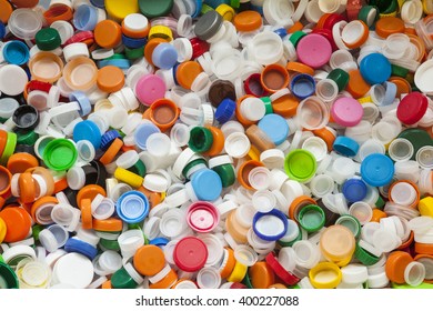 Hundreds Of Vividly Colored Plastic Screw-on Bottle Caps From Empty Drink Containers Ready For The Landfill Or To Use For Inspiring Recycled Or Up-cycled Arts And Crafts Projects