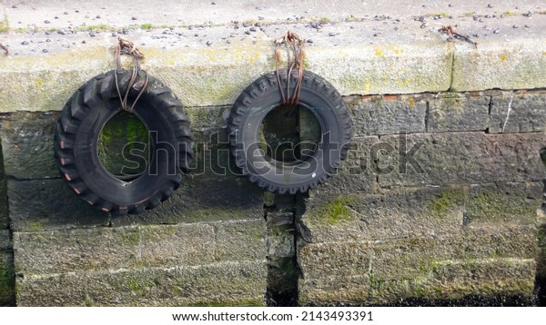 hung tires with chains\
near a river