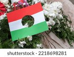 Hungarian flag with a hole , during the Hungarian uprising against the communist authorities in 1956, the communist arms were removed from the center of their flag, leaving a hole, memorial place