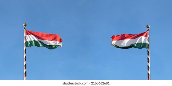 Hungarian flag or flag of Hungary waving against blue sky, panoramic view