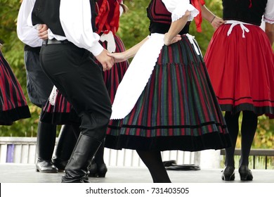 Hungarian Folk Dancers Dancing In Black, White And Red.