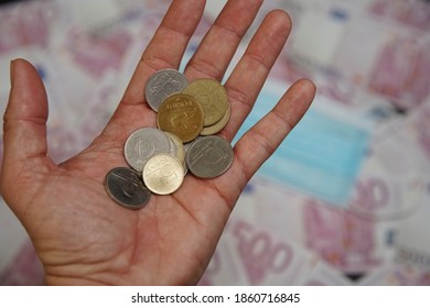 Hungarian Forint Money Coins In A Man 's Palm. In The Background Is A Medical Mask.