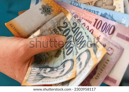 Hungarian forint money, Woman clutching a handful of banknotes, Large denominations, Inflation and financial situation in Hungary