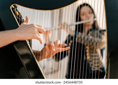 Hungarian harp and flute duo playing - Powered by Shutterstock