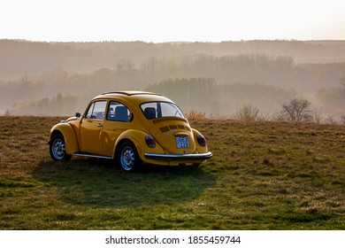 Hungary Budapest Nov, 11, 2020: A vintage yellow VB.W. parked on top of the hill at sunset. 