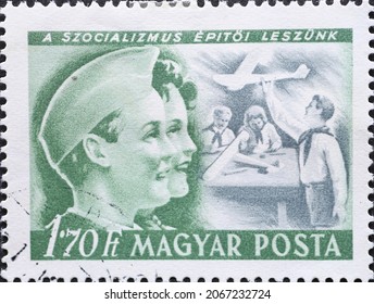 Hungary Circa 1950: A Post Stamp Printed In Hungary Showing Two Pioneers Building An Airplane Model During The International Children's Day 