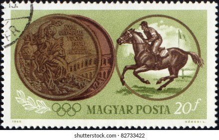 HUNGARY - CIRCA 1965: A Post Stamp Printed In Hungary Shows Jockey Riding Horse And Olympic Medal, Devoted To Olympic Games In Tokio, Circa 1965