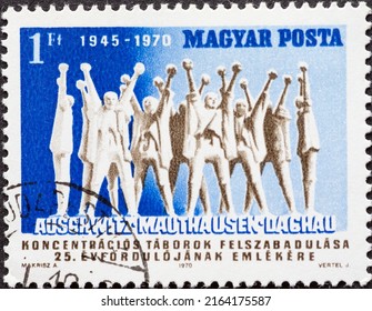 HUNGARY - CIRCA 1970: A Postage Stamp From HUNGARY, Showing Sculpted People With Arms Raised. 25th Anniversary Of The Liberation Of Concentration Camps Auschwitz, Dachau. Circa 1970