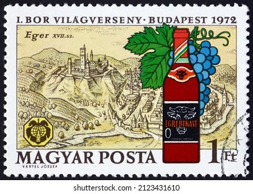 HUNGARY - CIRCA 1972: a stamp printed in Hungary shows Eger, 17th century view, and bottle of Bulls blood, wine, circa 1972