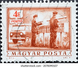 HUNGARY - CIRCA 1973: A Post Stamp Printed In Hungary Showing Two Postal Workers With Delivery Trucks. Postage Due - Rural Mail Delivery