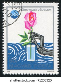 HUNGARY - CIRCA 1975: A Stamp Printed By Hungary, Shows Skeleton Hand Reaching For Rose In Water Glass, Circa 1975