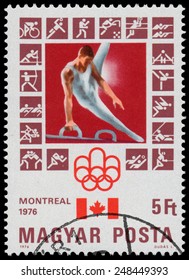 HUNGARY - CIRCA 1976: stamp printed in Hungary, shows Montreal Olympic Emblem, Canadian Flag, Athlete on vaulting horse, circa 1976 
