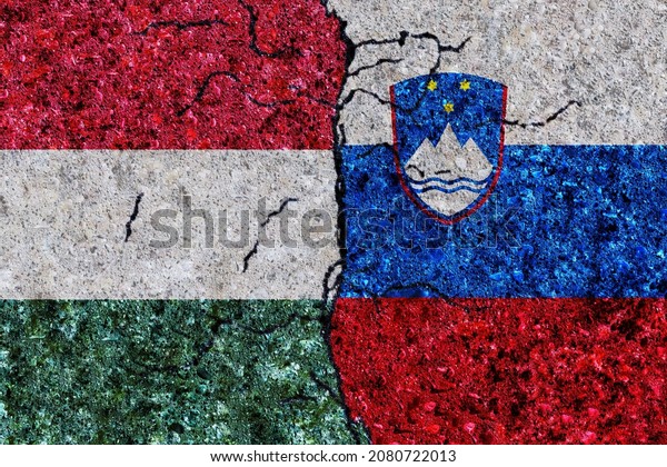 Hungary and Slovenia painted flags on a wall\
with grunge texture. Hungary and Slovenia conflict. Slovenia and\
Hungary flags together. Hungary vs\
Slovenia