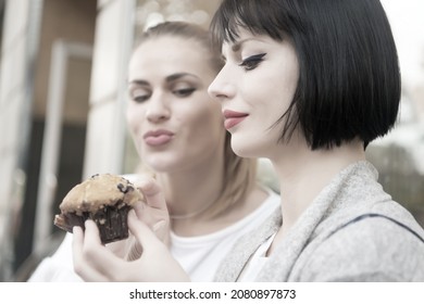 Hunger, Temptation, Appetite Concept. Women Look At Cupcake In Paris, France. Girl Friends With Blueberry Muffin In Cafe. Dessert, Food, Snack, Pastry.