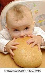 Hungry Baby Eating The Fresh Bread