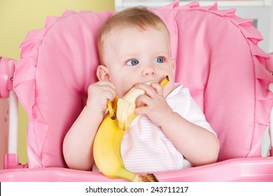 Hungry Baby Girl Eating A Banana