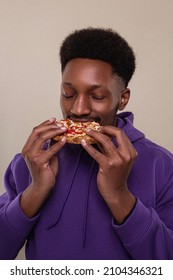 Hungry Black Man Bites Very Big Piece Of Pizza, Has Appetite, Enjoys Eating Fast Food In Office