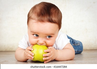 Hungry Little Baby Boy Eating Apple