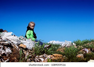 A Hungry Little Girl Is Sitting On A Dump