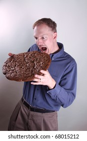 Hungry Man Eating A Giant Cookie