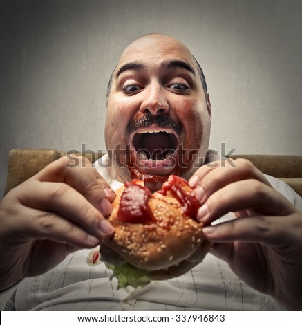 Hungry man eating a hamburger